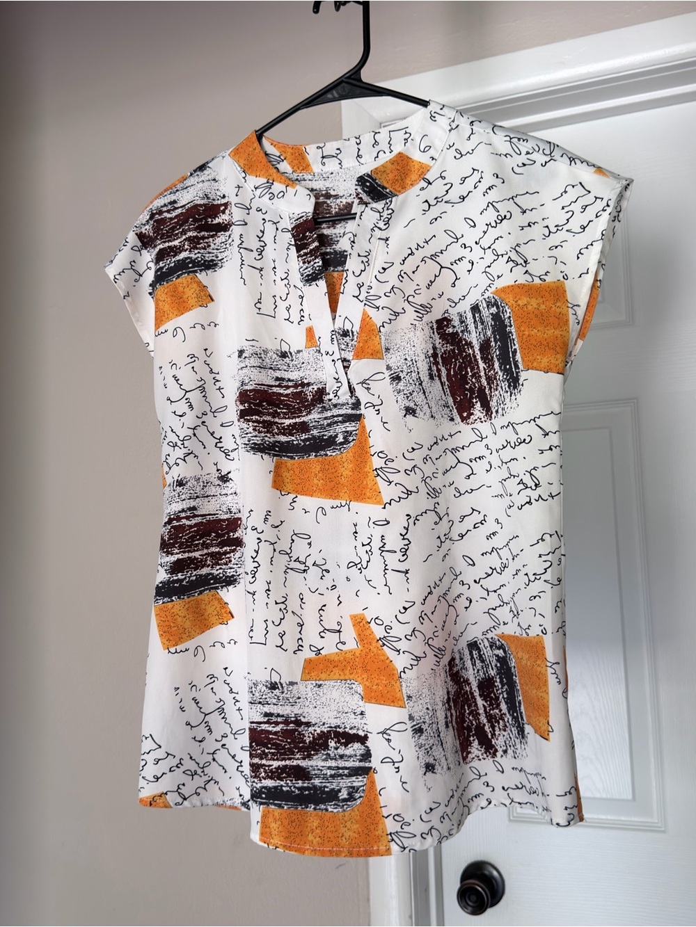 SHEIN White Sleeveless Blouse with Orange and Brown Script Print